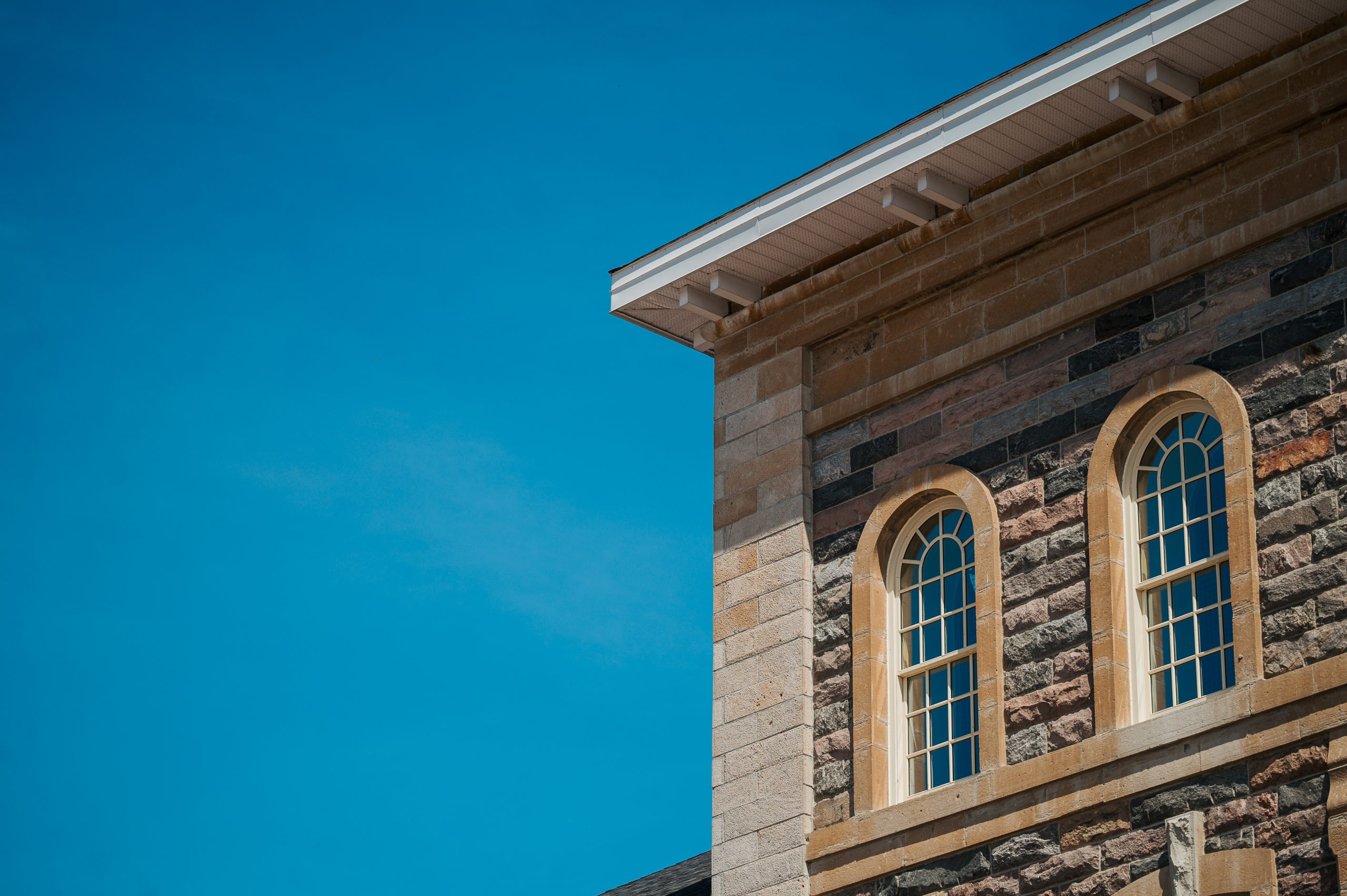 A picture of the top corner of our admin building next to a bright blue sky.