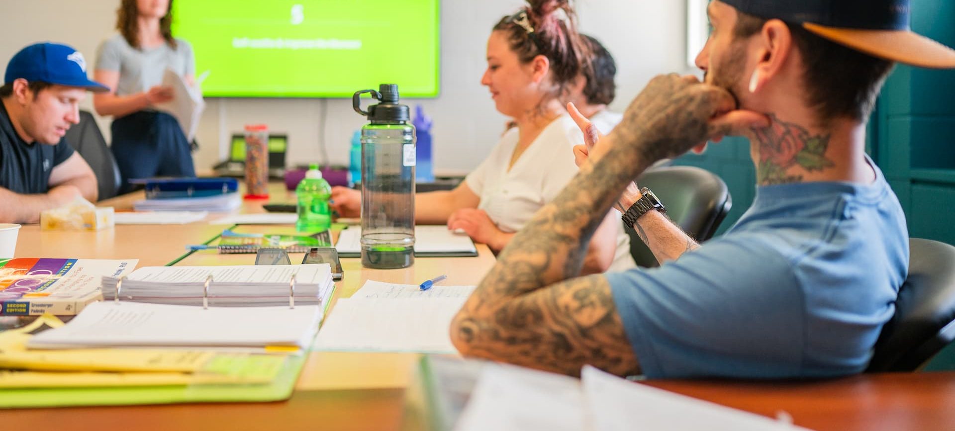 A group of people sitting in a cognitive behavioural therapy group session.