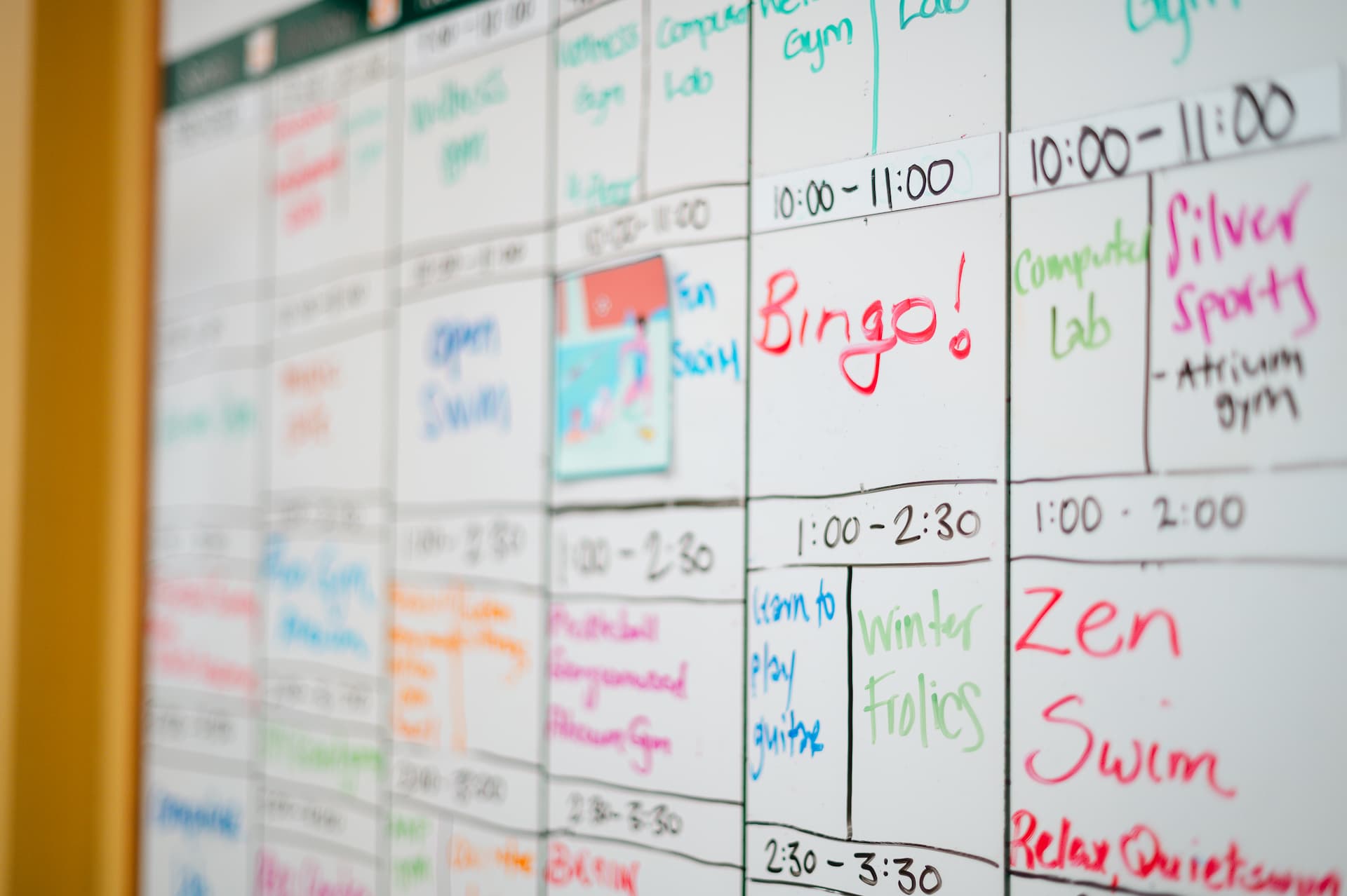 A white board with a calendar full of activities.