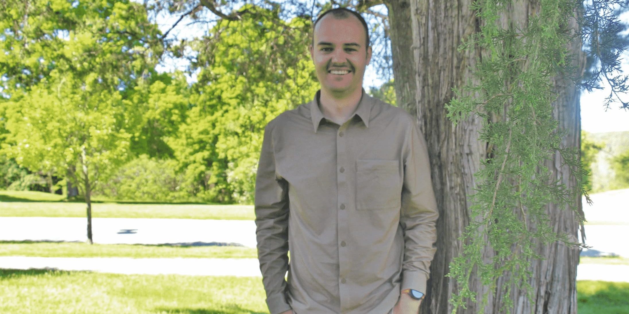 Peter Dangerfield standing outside beside a tree.