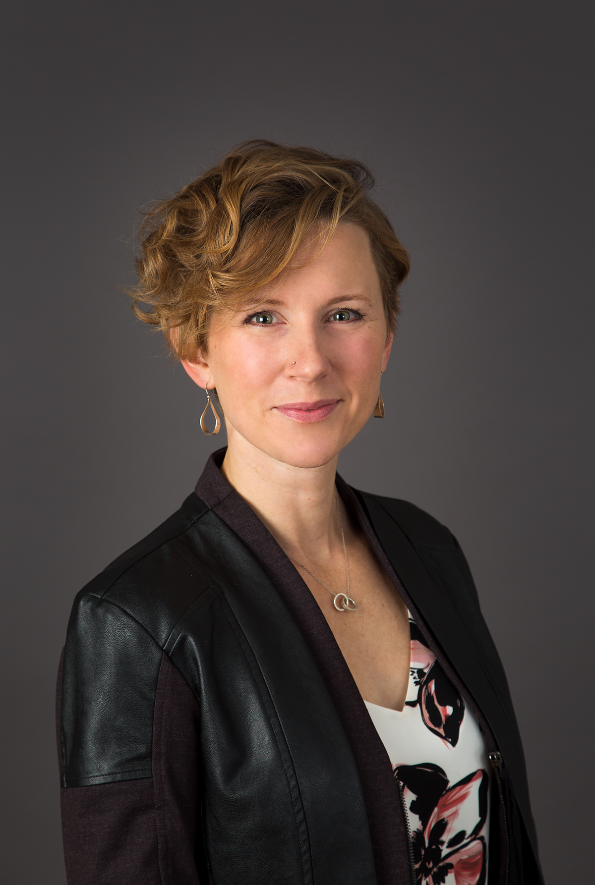 A staff headshot of Dr. Van Iersal smiling in front of a black background.