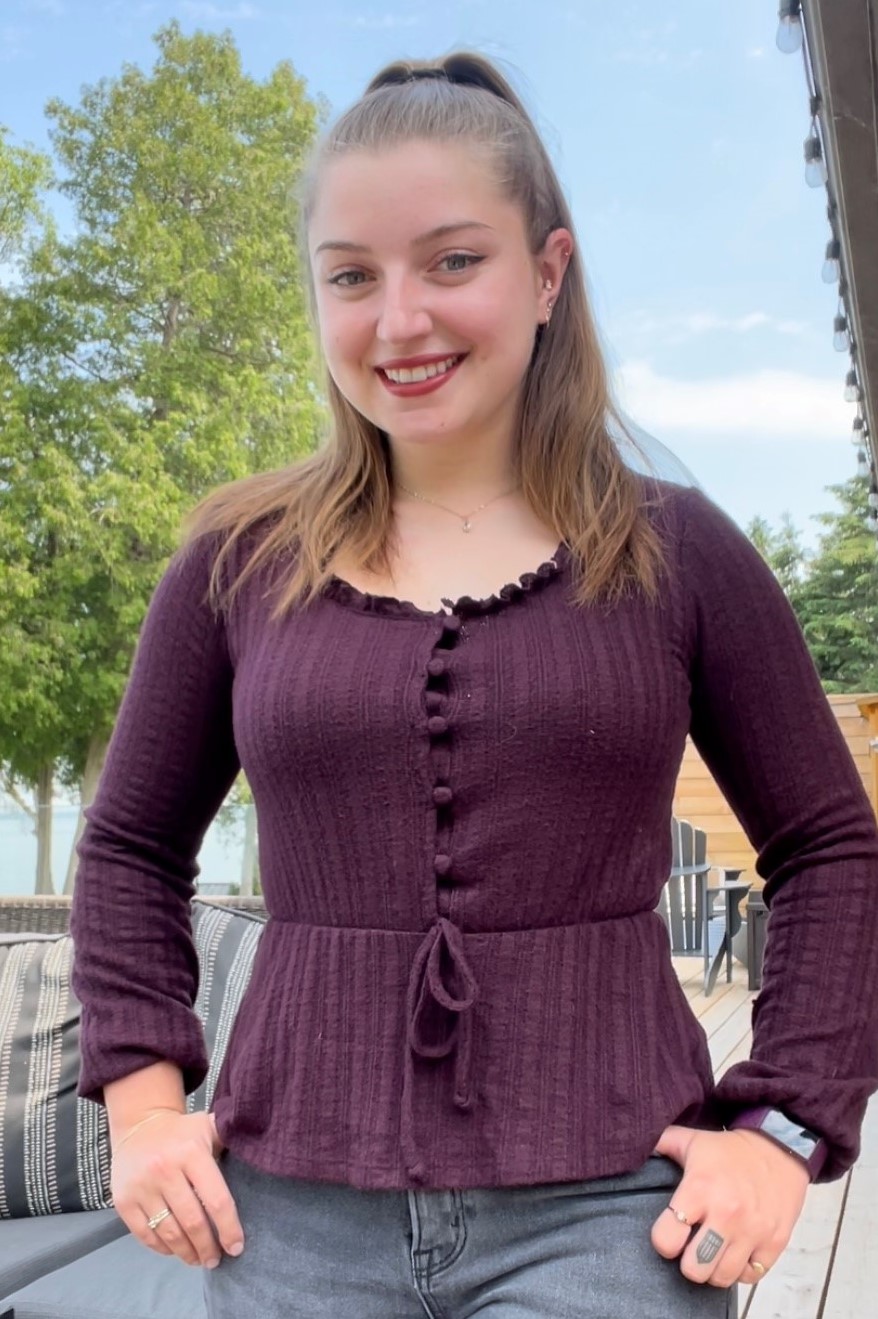 A staff headshot of Stephanie Farr smiling with blue skies and trees surrounding.