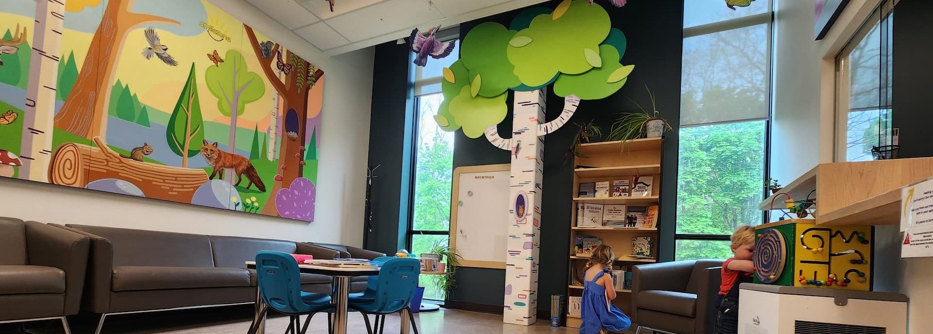 Two children playing in a child-friendly waiting room.