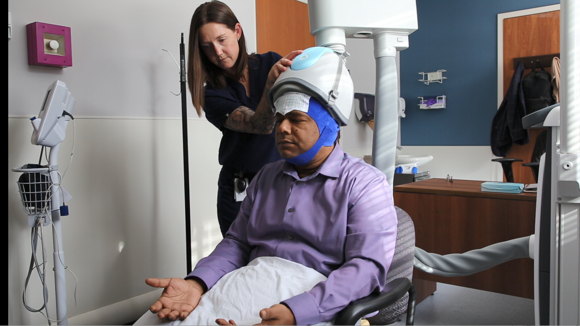A nurse providing rTMS treatment to a patient.