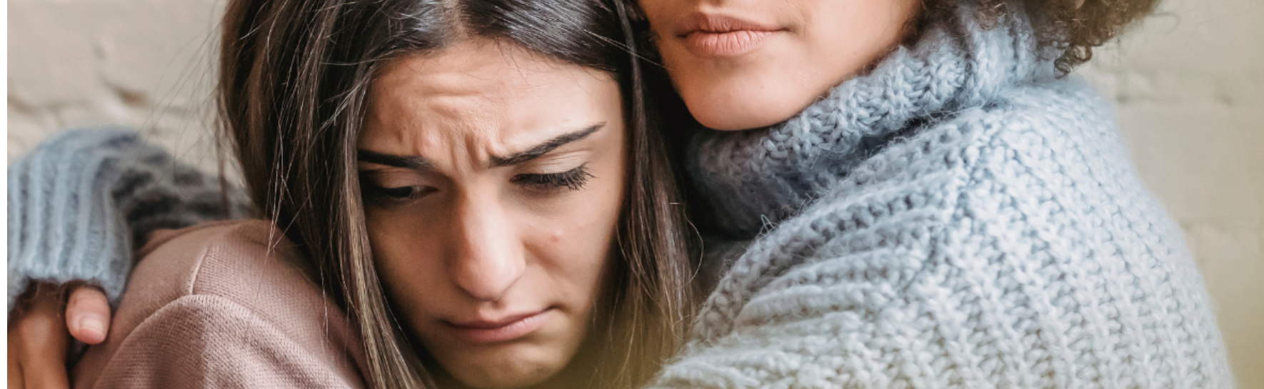 a lady consoling another person