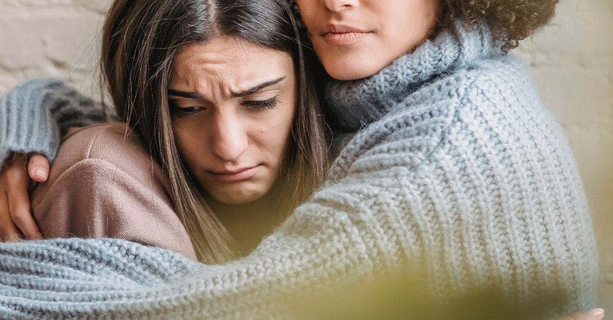 A person consoling another person